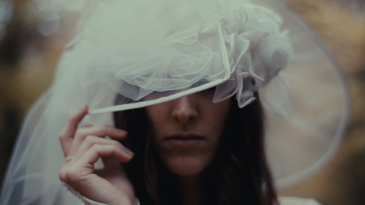 Woman in an elaborate white hat or veil
