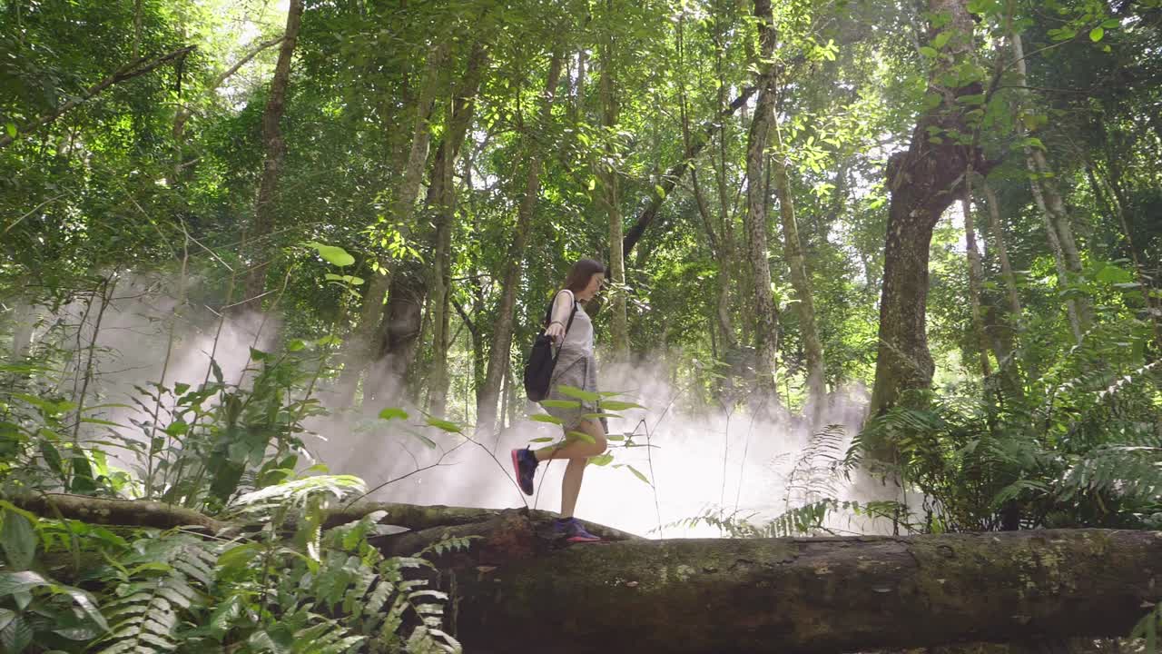 Woman Hiking Through a Misty Forest