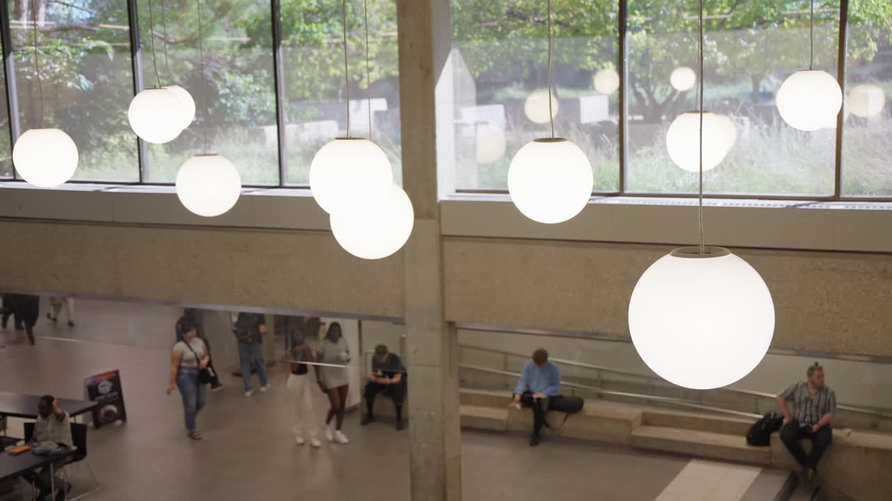 Balcony view of University of Manitoba interior showing students and illuminated building