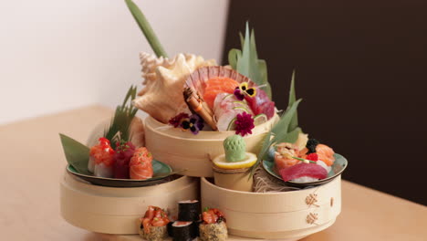 Sushi-And-Sashimi-Rolls-Arranged-Creatively-In-A-Plate-In-A-Sushi-Restaurant---tilt-down-shot