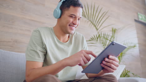 headphones, tablet and a happy man watching online