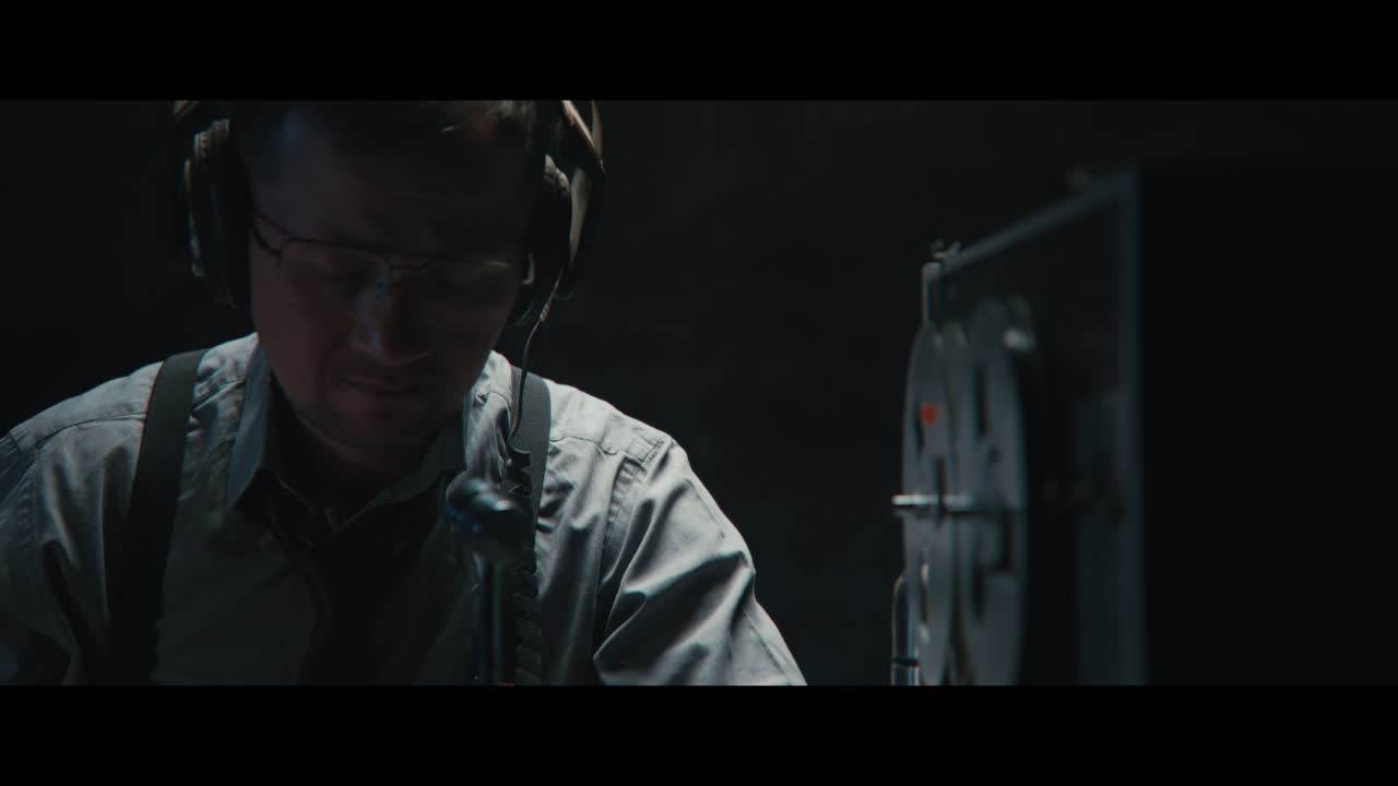 An intelligence officer listens to the wiretap recordings