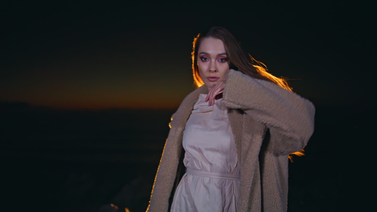 Portrait trendy model partying at night nature looking camera. Girl dancing