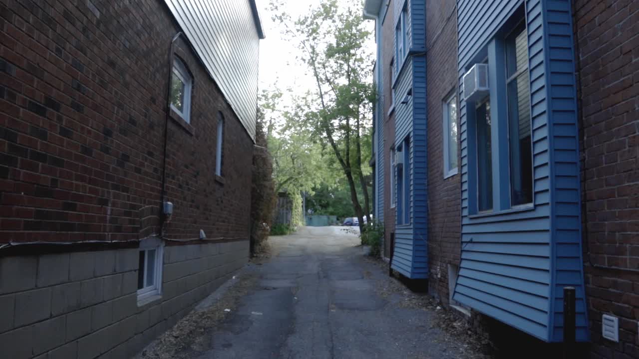 Narrow Asphalt Walkway Between Residential Buildings - midshot