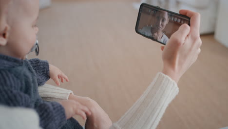 mother-and-baby-using-smartphone-having-video-chat-with-best-friend-waving-at-toddler-happy-mom-enjoying-sharing-motherhood-lifestyle-on-mobile-phone-screen