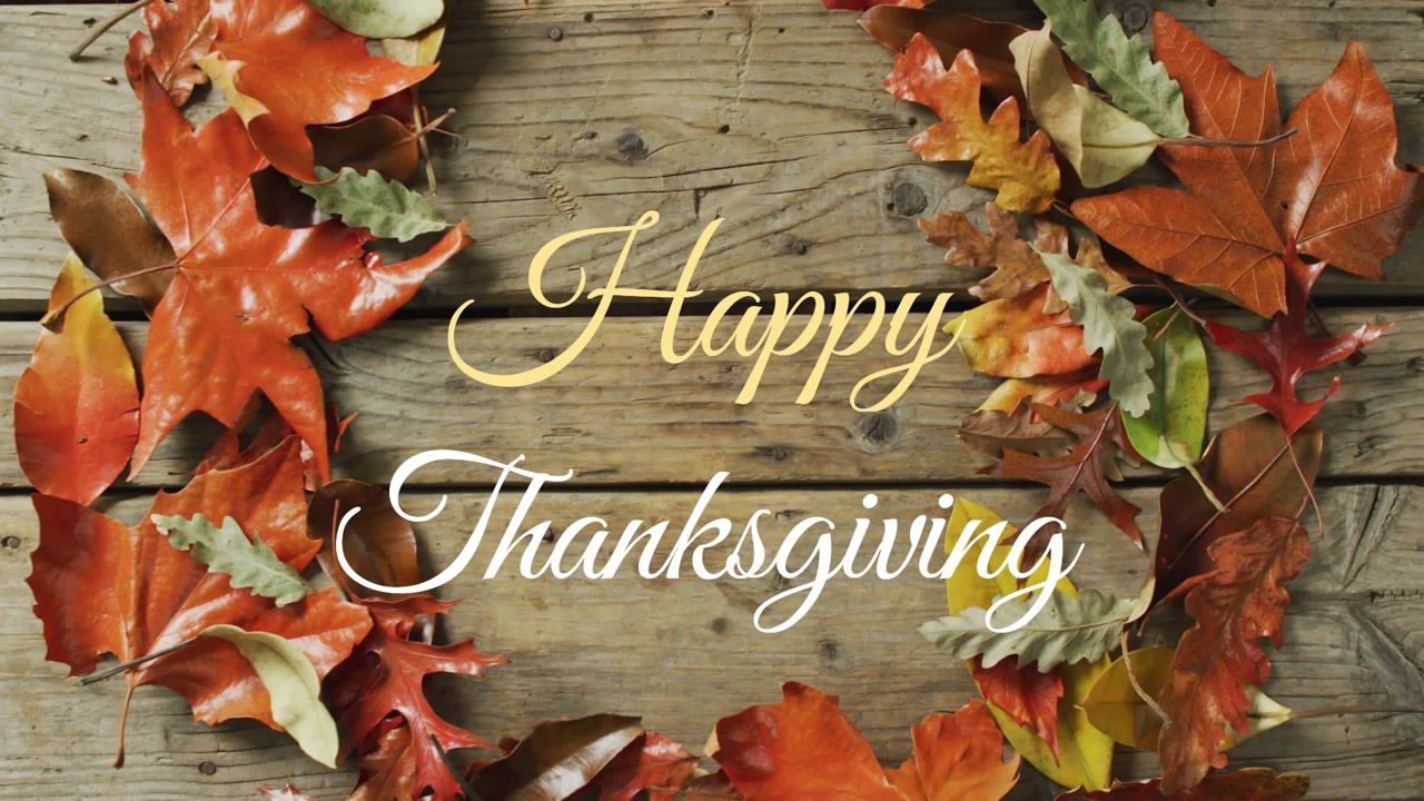 Launching greeting screen showing wood plank with autumn leaves framing Happy Thanksgiving text