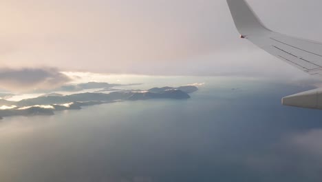 flying over the picton and the marlborough sounds in south island of new zealand, aotearoa on a cloudy day