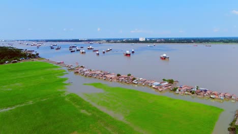 aerial view of a river with ships and a village