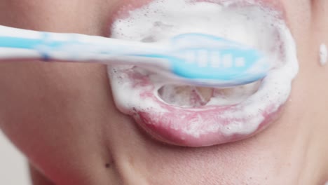 man brushing teeth with a manual toothbrush