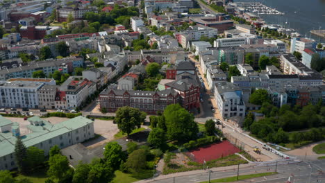 Aerial-view-of-urban-neighbourhood-next-to-marina-on-Unterwarnow-river.-Rising-footage-of-cityscape