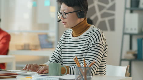 asian call center agent working in office