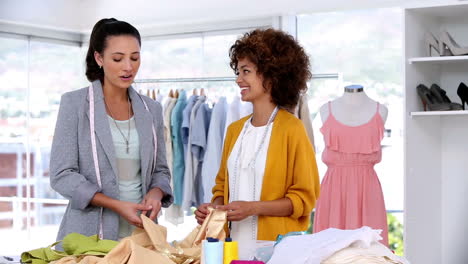 pretty fashion designers working together with a fabric