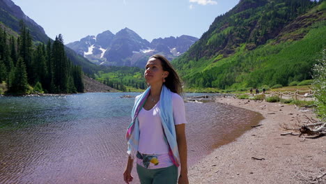 Maroon-Bells-Aspen-Snowmass-wilderness-hiking-trail-shoreline-lake-women-female-model-actress-hair-blowing-in-wind-14er-Capital-peaks-Rocky-Mountain-Colorado-summer-stunning-morning-cinematic-pan