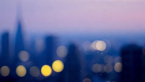 dust particles slowly fall and float over a blurred cityscape, creating an atmospheric effect in the evening light