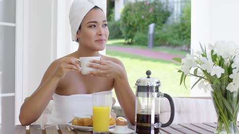 grinning woman at breakfast table outdoors