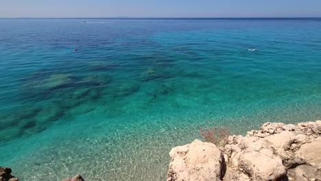 panoramic sea scene of blue turquoise seawater from rocky shoreline on a summer vacation day in mediterranean