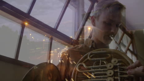 boy playing french horn by slanted window, showing music education theme with motion graphics notes