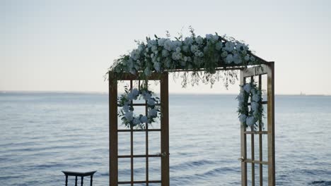 wedding ceremony arrangement on the shoreline of a large body of water