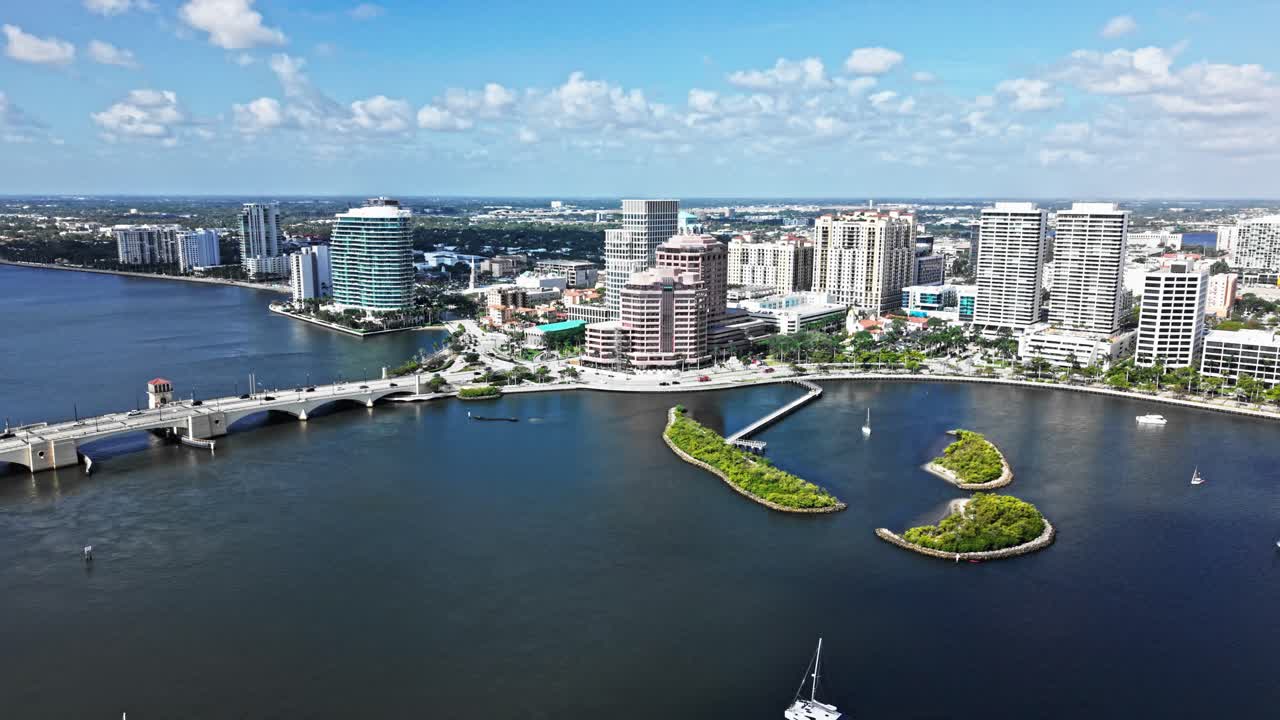 Aerial: One Flagler, Phillips Point Building and West Palm Beach cityscape during the day in Florida, USA, orbit drone shot