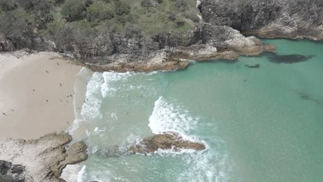 People-At-South-Gorge-Beach-With-Blue-Sea-In-Summer---Tourist-Attraction---Point-Lookout,-Queensland,-Australia