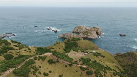aerial view of the stunning muelle de las almas in chonchi, chile, showcasing the dramatic coastline and the vastness of the pacific ocean. dolly right