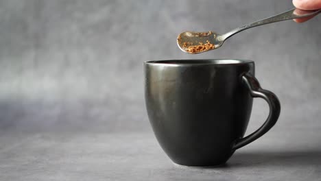 Close-up-of-mixing-coffee-power-with-hot-water