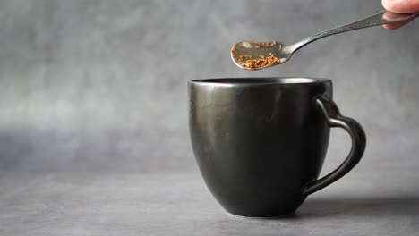close up of mixing coffee power with hot water