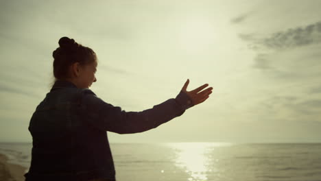 Little-girl-enjoying-beach-sea-water.-Child-playing-skipping-stone-in-ocean.