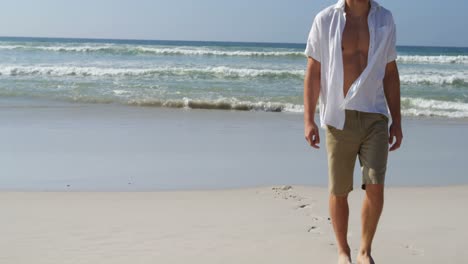 man in hat walking at beach on a sunny day 4k