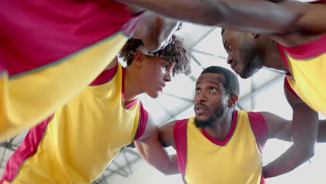 Diverse-basketball-team-in-a-huddle