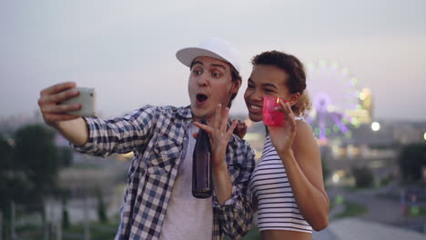 happy couple taking selfie at night