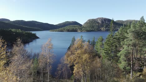 idyllic scenery of lake, forest and mountains in hildremsvatnet, norway - aerial drone shot