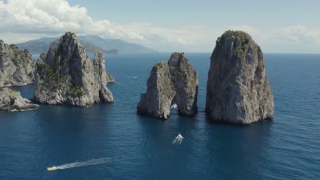 iconic sight of famous faraglioni sea stacks on capri coast