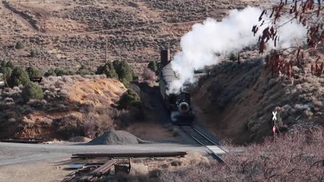 old steam engine train moving down train tracks