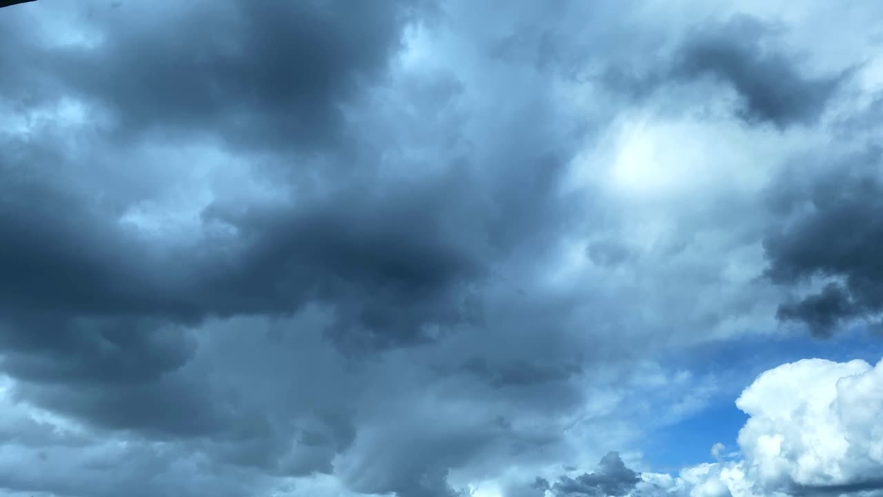 Contrasting sky with clouds running fast in the sky, changing clouds before the storm