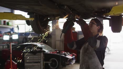 Animation-of-network-of-blue-hexagons-over-caucasian-woman-fixing-car