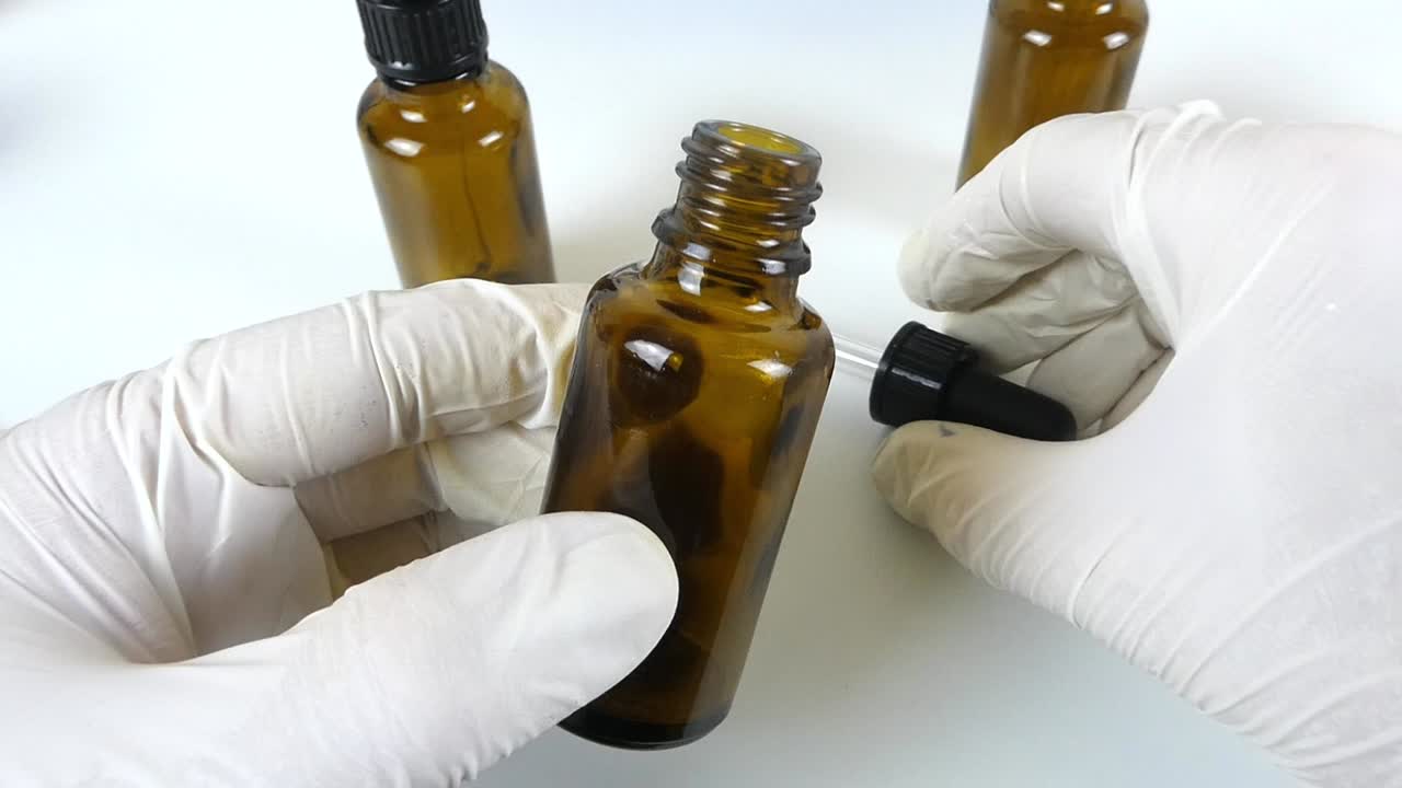 A captivating macro video showcasing a cosmetic serum dripping in slow motion, emphasizing its silky texture and transparency.