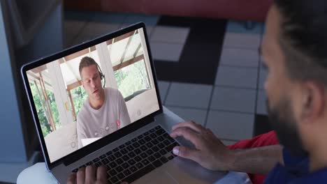 Middle-eastern-man-having-a-video-call-with-male-office-colleague-on-laptop