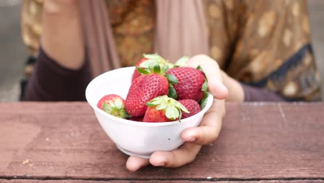 woman eating strawberries