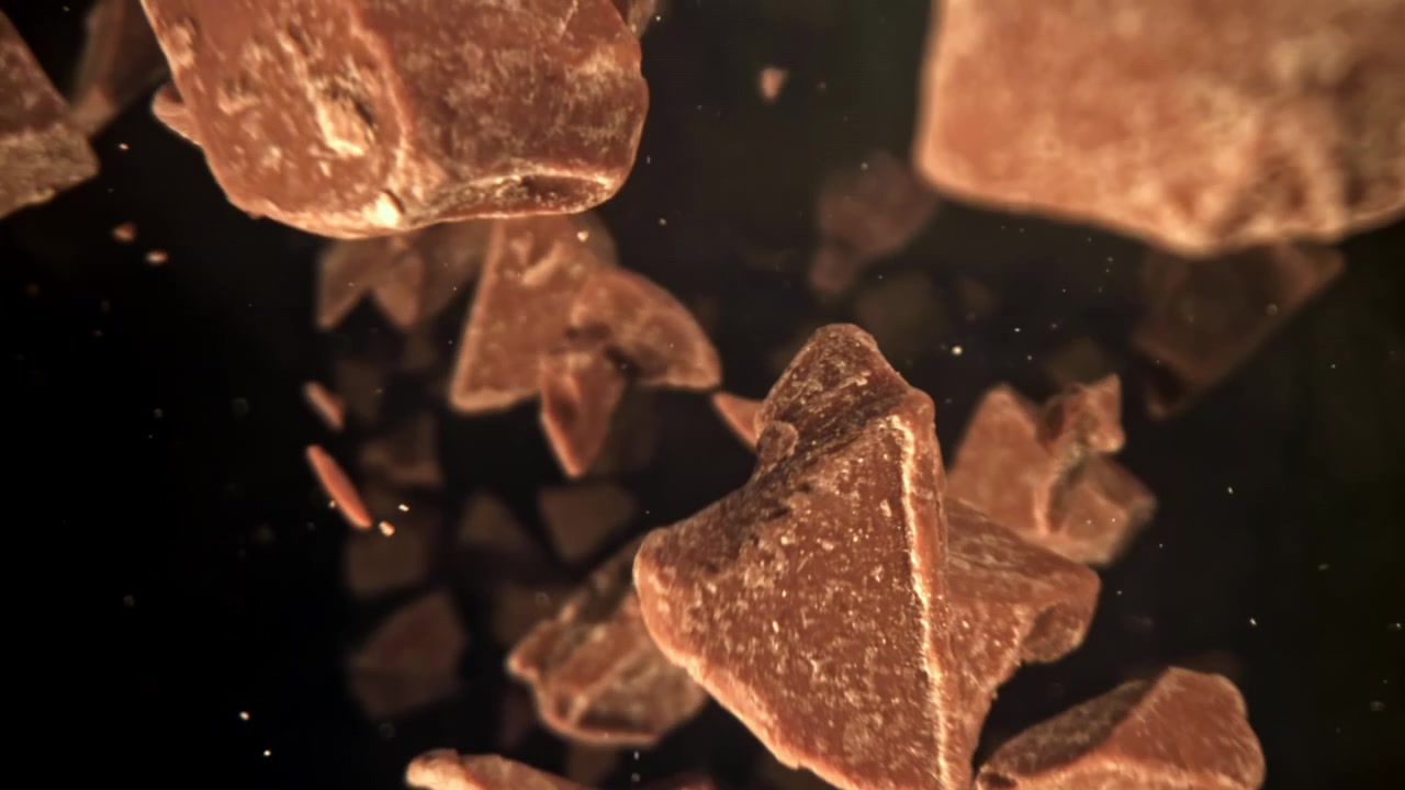 Slow Motion Falling Chocolate Chunks on Dark Background