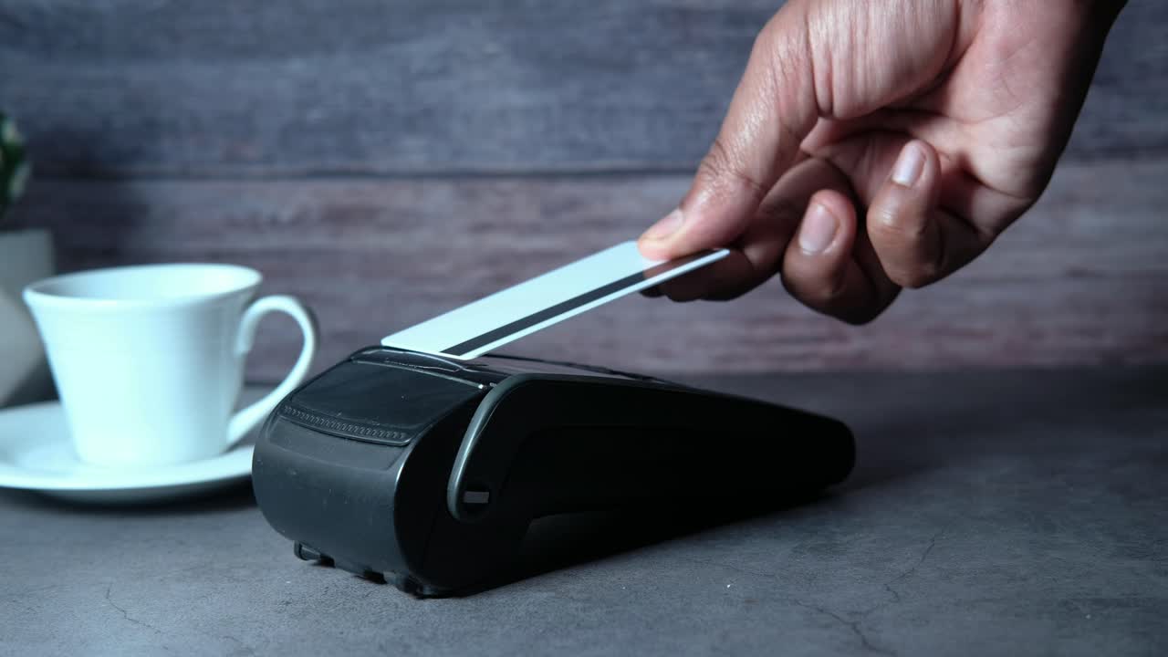 Person Paying with Credit Card at Point of Sale Terminal