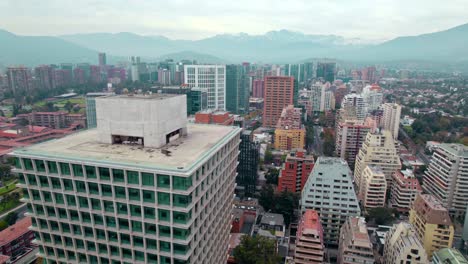 Aerial-view-around-vibrant-building,-in-cloudy-Escuela-Militar,-Santiago-de-Chile