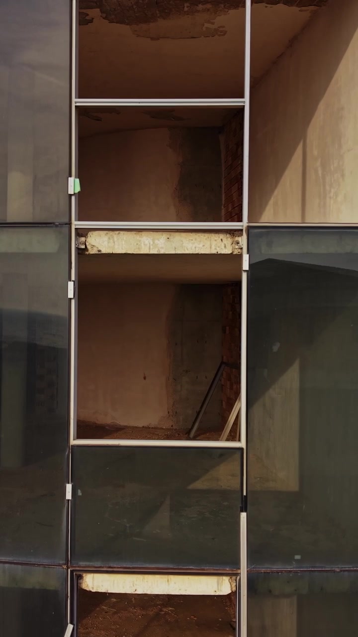 Construction site with modern glass facade during daylight hours