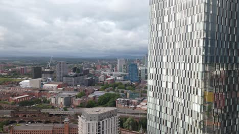 establishing aerial view manchester deansgate modern city centre skyscraper overlooking downtown district skyline