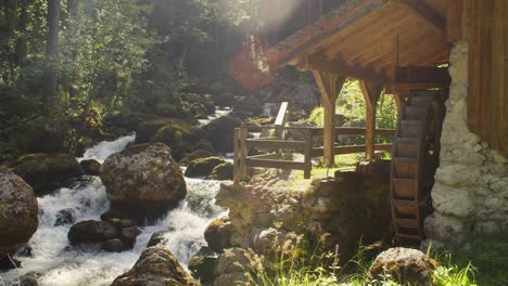 Peaceful-river-stream-with-old-water-mill-in-Gollinger,-Austria,-wide-shot