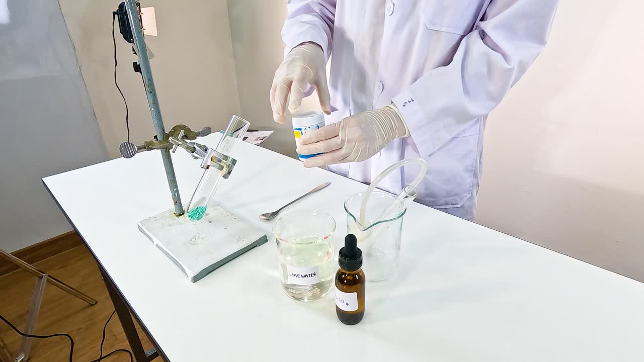 A scientist conducts a chemical reaction between copper carbonate and sulfuric acid in a laboratory setting