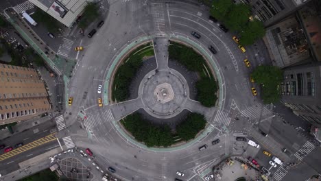 Aerial-view-above-traffic-driving-around-the-Columbus-Circle,-in-NYC,-USA---rotating,-top-down,-drone-shot