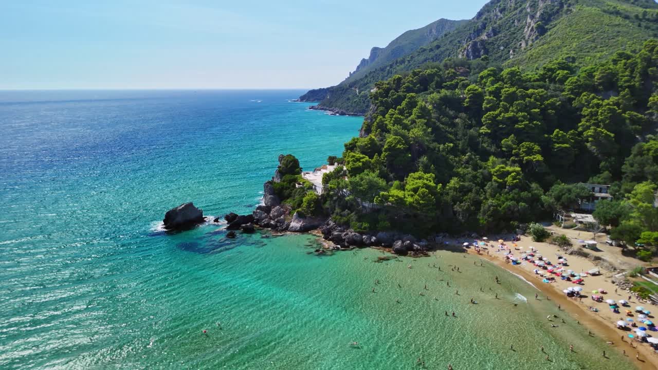 Aerial view of beach, people relaxing, clear water, summer, Greece