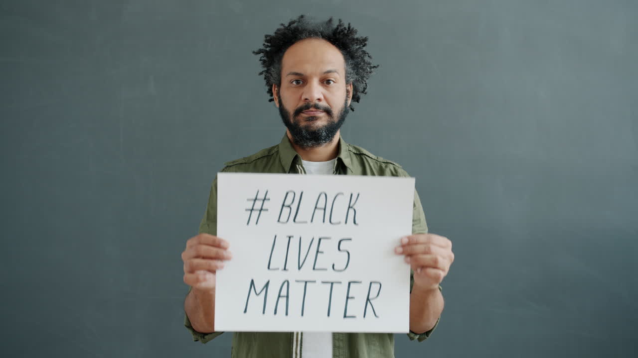 Man Holding "Black Lives Matter" Sign