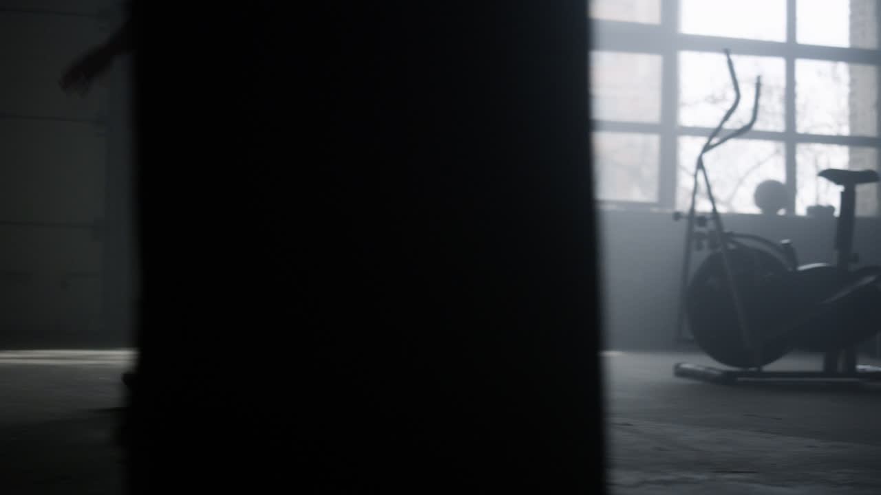 Sporty woman starting to run in gym. Powerful runner running in crossfit club